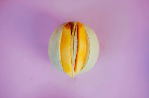 pexels-photo-3773666-3773666 Top view of a sliced melon on a bold pink surface, showcasing contrast and freshness.